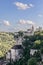 Group of massive religious buildings half-way up cliff and castle onÂ summit of medieval historical village Rocamadour